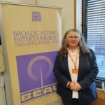 WGGB Deputy General Secretary Lesley Gannon in front of a BEAU banner in Parliament